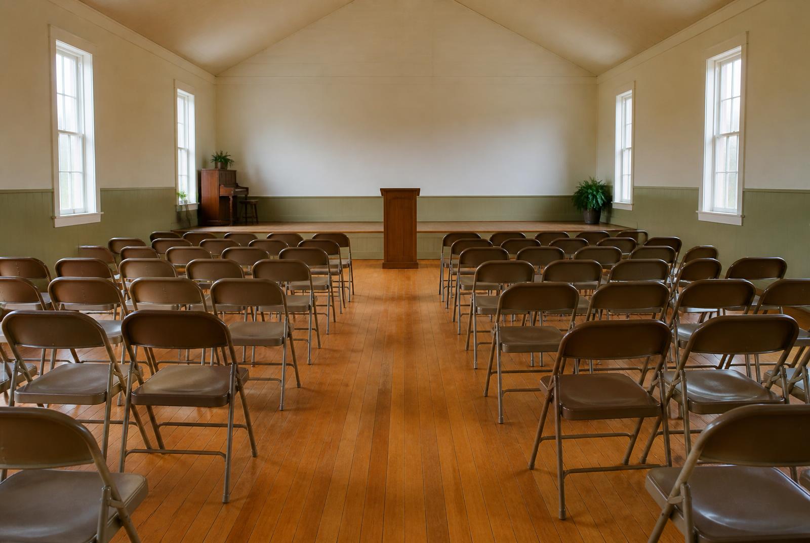 Empty community hall set with folding chairs for a town meeting